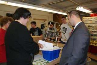 Junior Ricky Wecera reviews the design of the pyramid which is included in the 2013 FIRST Robotics Challenge with Legislator Calarco. Pictured, left to right: Ricky Wecera, Legislator Calarco.