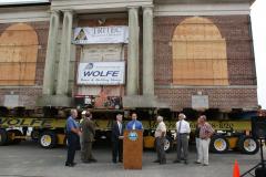 Leg. Rob Calarco at the podium speaking to the crowd that has come to see the historic Carnegie Library moved by Wolfe House &amp; Building Movers of Bernville, Pa. Pictured to left of Leg. Calarco is County Executive Steve Bellone; to the right is Patchogue Mayor Paul Pontieri and village trustees.